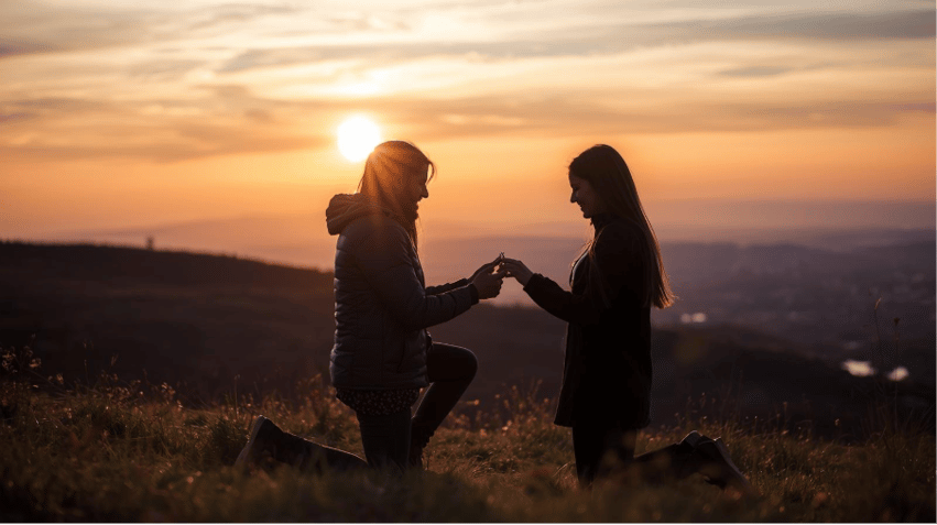 A couple of people kneeling on a hill holding hands

AI-generated content may be incorrect.